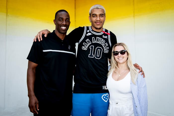 Spurs Sports & Entertainment's Brandon James (left) poses with Spurs rookie forward Jeremy Sochan in front of Josef Kristofoletti’s mural, Tau Ceti, located in Downtown Austin, March 27, 2023.